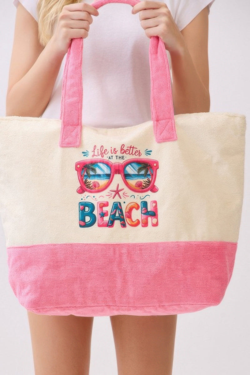 The model presents the Life Is Better At The Beach Tote Bag from HD ACCESSORIES, highlighting its charming beach theme. This practical and stylish tote bag is ideal for summer outings and is a perfect choice among accessories, handbags, and new arrivals.