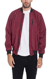 Model showcasing a Burgundy Lightweight Windbreaker Jacket by Astral Signature™. This stylish jacket offers a modern look for various occasions. Keywords: Windbreaker Jacket, Black, Burgundy, CCPRODUCTS, Grey, MENS, MENS OUTERWEAR, MENS TOPS, NEW ARRIVALS.