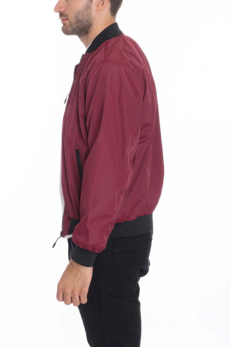 Model presenting a side view of a Burgundy Lightweight Windbreaker Jacket from Astral Signature™, combining elegance and functionality. Keywords: Windbreaker Jacket, Black, Burgundy, CCPRODUCTS, Grey, MENS, MENS OUTERWEAR, MENS TOPS, NEW ARRIVALS.
