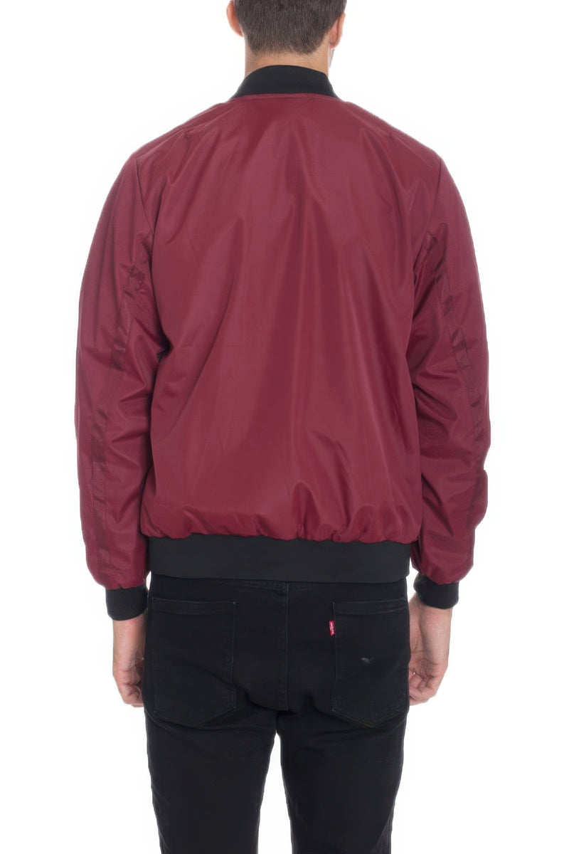 Back view of a model in a Burgundy Lightweight Windbreaker Jacket by Astral Signature™, highlighting its comfortable fit and stylish design. Keywords: Windbreaker Jacket, Black, Burgundy, CCPRODUCTS, Grey, MENS, MENS OUTERWEAR, MENS TOPS, NEW ARRIVALS.