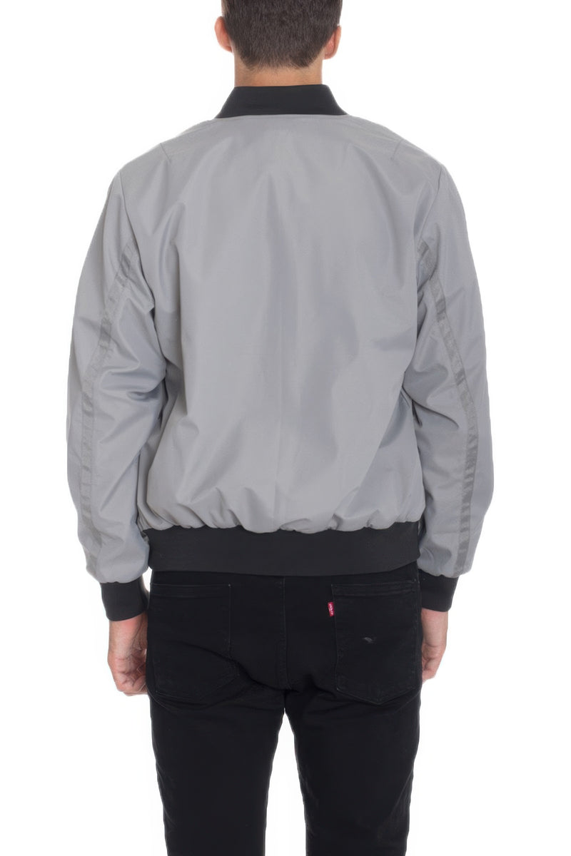 Back view of a model wearing a Grey Lightweight Windbreaker Jacket by Astral Signature™, emphasizing its stylish and functional design. Keywords: Windbreaker Jacket, Black, Burgundy, CCPRODUCTS, Grey, MENS, MENS OUTERWEAR, MENS TOPS, NEW ARRIVALS.