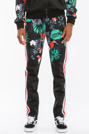 Front view focus of a male model in the Printed Polyester Track Set for Men by Astral Signature™, emphasizing the stylish floral print on the track pants. Great for active and casual settings. Active, Activewear, Black, CCPRODUCTS, MENS, MENS SETS, NEW ARRIVALS, Track Set.