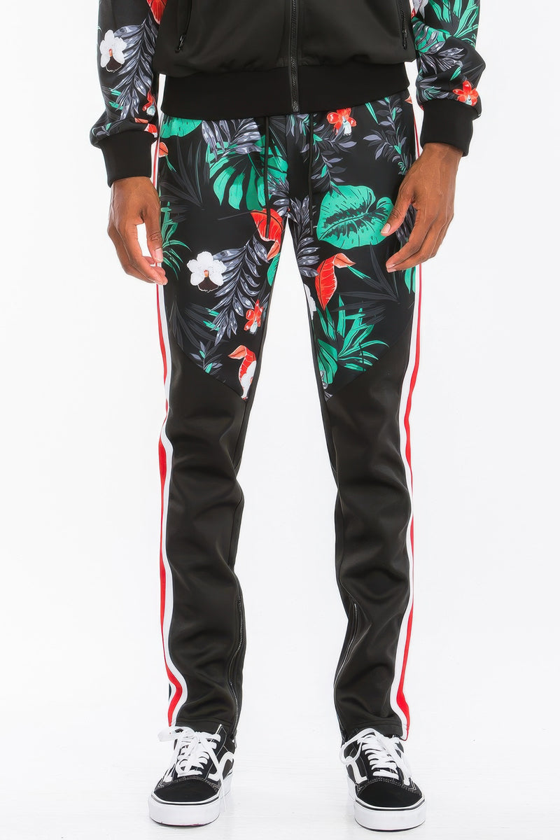 Front view focus of a male model in the Printed Polyester Track Set for Men by Astral Signature™, emphasizing the stylish floral print on the track pants. Great for active and casual settings. Active, Activewear, Black, CCPRODUCTS, MENS, MENS SETS, NEW ARRIVALS, Track Set.