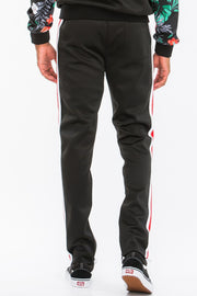 Rear view of a male model in the Printed Polyester Track Set for Men by Astral Signature™, showcasing sleek lines and stylish ankle zippers. A must-have in activewear for modern men. Active, Activewear, Black, CCPRODUCTS, MENS, MENS SETS, NEW ARRIVALS, Track Set.