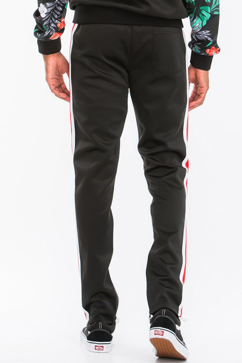 Rear view of a male model in the Printed Polyester Track Set for Men by Astral Signature™, showcasing sleek lines and stylish ankle zippers. A must-have in activewear for modern men. Active, Activewear, Black, CCPRODUCTS, MENS, MENS SETS, NEW ARRIVALS, Track Set.