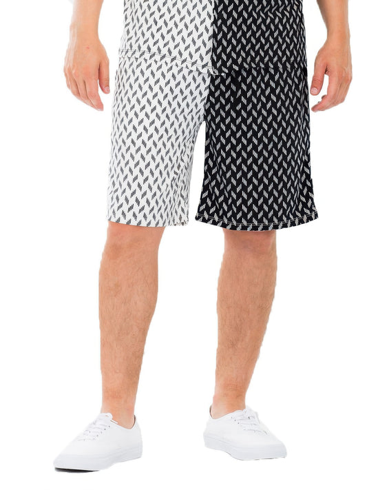 Model wearing Diamond Two-Tone Print Shorts from Astral Signature™, showcasing a unique geometric design in a black and white color scheme. Ideal for casual summer days, these shorts are part of the MENS, MENS BOTTOMS, Multi, and NEW ARRIVALS collection.