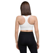 Model showcasing the side angle of the Astral Signature Longline Sports Bra, emphasizing its form-fitting and stylish design for activewear.