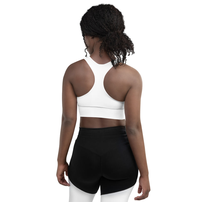 Back view of a model wearing the Astral Signature Longline Sports Bra, emphasizing its supportive features, ideal for active pursuits.