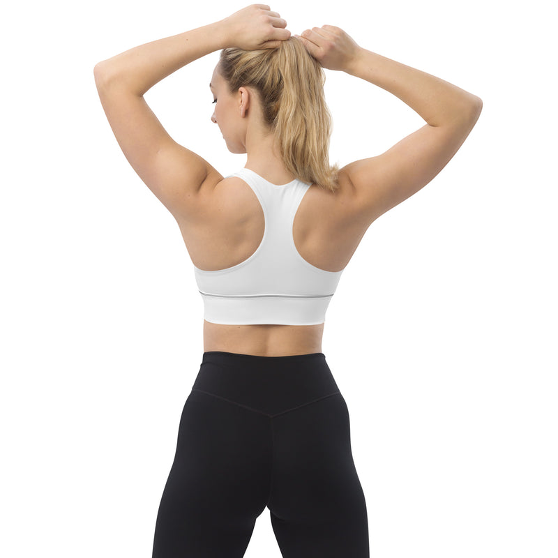 Model in the Astral Signature Longline Sports Bra, illustrating flexibility and stylish design appropriate for various workout activities.