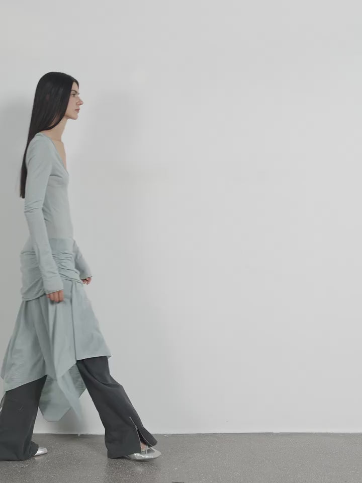 Dynamic model pose in the Dreamy Ball Wool Dress by PremiumStyle Co.,Limited, showcasing the fluid movement and stylish asymmetric hem in light gray. This Asymmetric Hem Wool Dress is an exemplary piece of women's fashion for modern wardrobes.