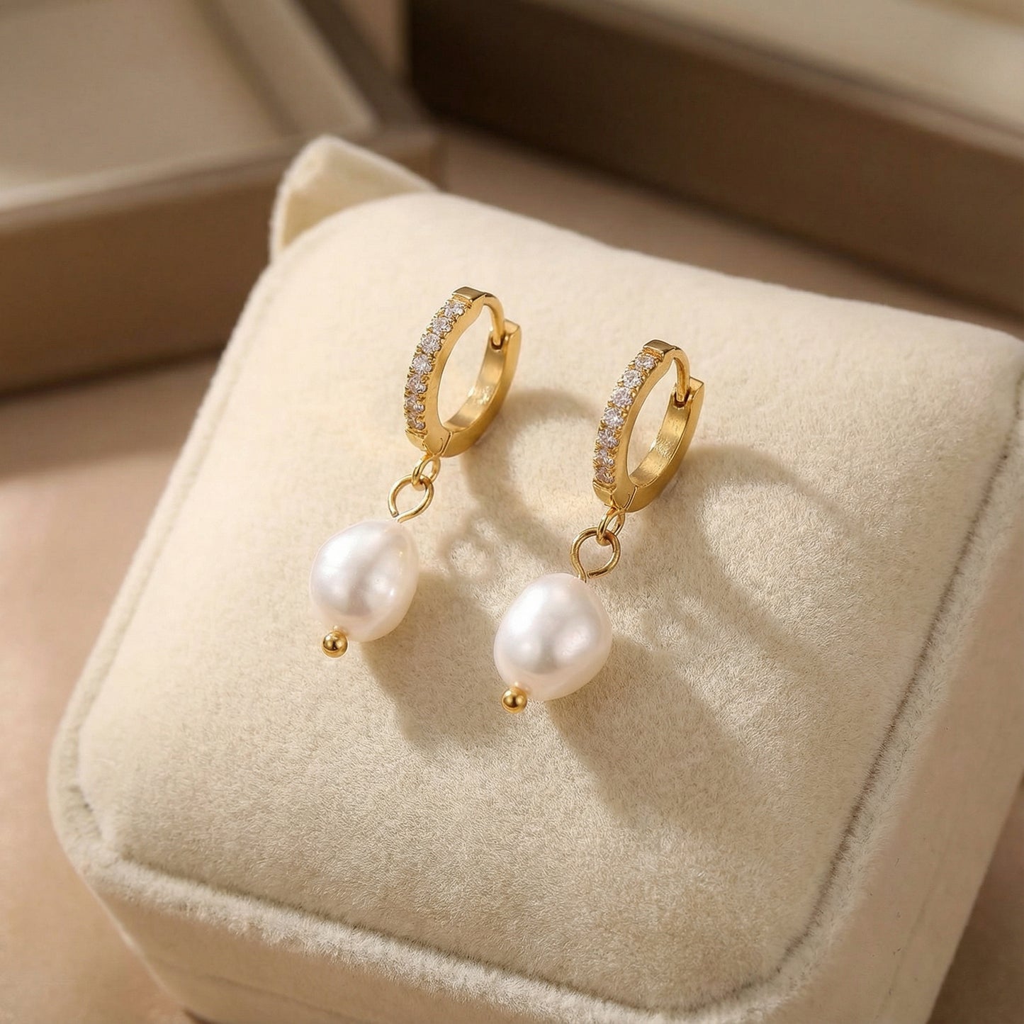 Pearl Drop Hoops - Freshwater Pearl - 18K Gold Plated Stainless Steel by Astral Signature displayed on a soft cushion, emphasizing their refined beauty. This jewelry is a fantastic everyday wear piece and an excellent gift for her, reflecting the stylish Astral Design in limited edition.