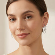 Model showcasing Stardust Chain Studs by Astral Signature, highlighting Eco-Brass earrings that offer a unique star design. These lightweight stud earrings, featuring Zirconia accents, are a thoughtful gift for her.