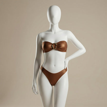 Display of the Bronze Halter Bikini With Gold Ring Detail by Stylish Swimwear on a mannequin, highlighting its elegant design. This dark brown bikini fits perfectly within categories such as APPAREL, CCPRODUCTS, NEW ARRIVALS, and SWIMWEAR & COVER-UPS.