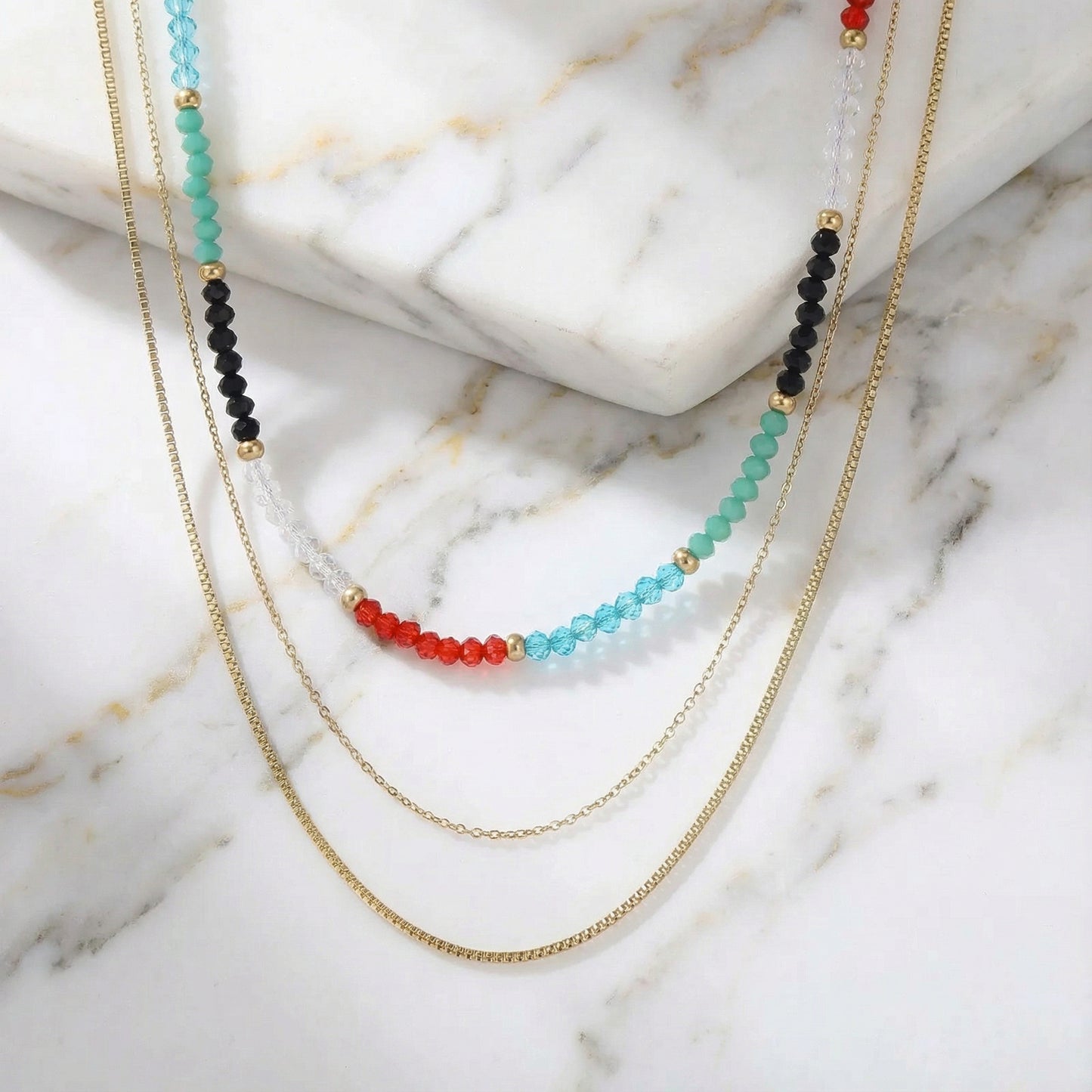 A detailed shot of the Rainbow Aura Layers necklace featuring 14K Gold Plated Stainless Steel and vibrant beads by Astral Signature. This stylish jewelry is perfect for everyday wear, making it an ideal gift for her and a unique limited edition accessory.