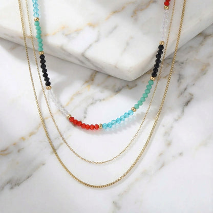 A detailed shot of the Rainbow Aura Layers necklace featuring 14K Gold Plated Stainless Steel and vibrant beads by Astral Signature. This stylish jewelry is perfect for everyday wear, making it an ideal gift for her and a unique limited edition accessory.