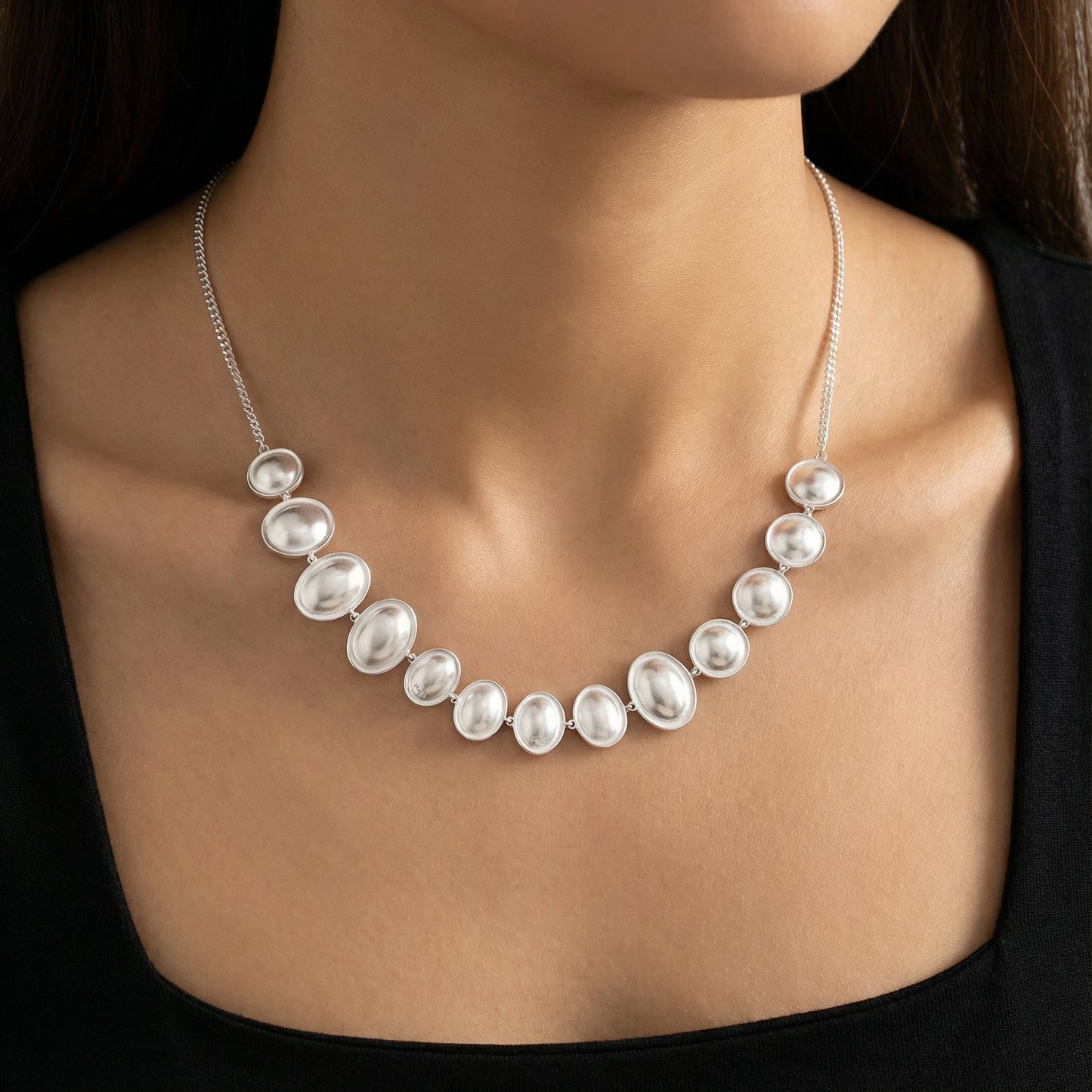 Close-up of the Lunar Pearl Arc Necklace - Sterling Silver by Astral Signature, showcasing its unique graduated design and shimmering details. A beautiful gift for her, this necklace symbolizes elegance and is part of the limited edition collection.