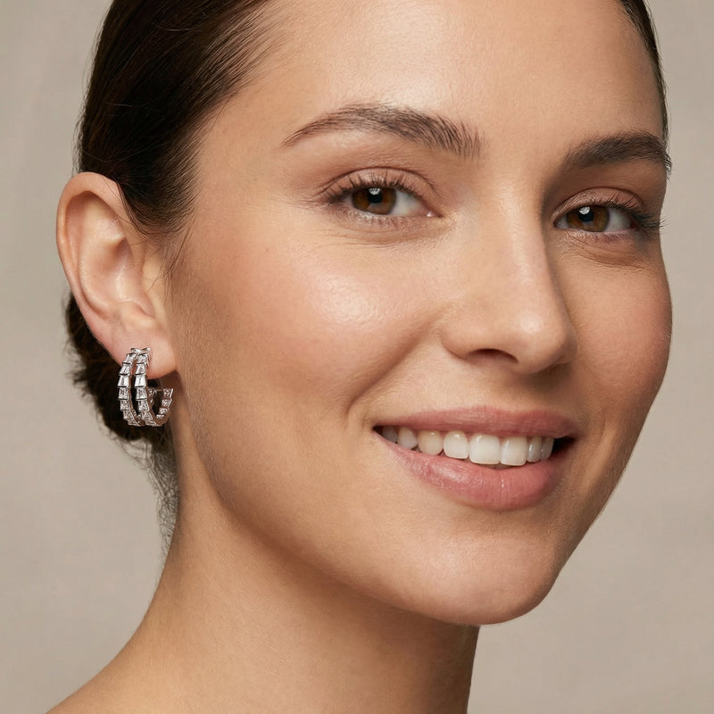 Close-up of a model wearing the Crystal Avenue Hoops, elegant Eco-Brass earrings by Astral Signature, highlighting the zirconia sparkle and the hypoallergenic S925 sterling silver posts.