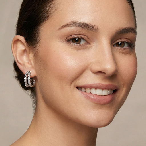 Close-up of a model wearing the Crystal Avenue Hoops, elegant Eco-Brass earrings by Astral Signature, highlighting the zirconia sparkle and the hypoallergenic S925 sterling silver posts.