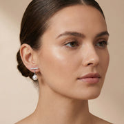 A side profile of a woman wearing the Pearl Drop T-Bar Earrings - Freshwater Pearl - Rhodium-Plated 925 Sterling Silver by Astral Signature. The earrings reflect a blend of modernity and elegance, perfect for any occasion. An ideal everyday wear option or a thoughtful gift for her, these earrings are featured in the Limited Edition collection by Astral Design.