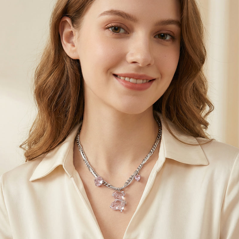 Model wearing the Blush Dreams Chain by Astral Signature, featuring a white gold plated eco-brass bear pendant embellished with zirconia stones. This elegant necklace is styled with a leather cord, perfect for a chic and playful look.