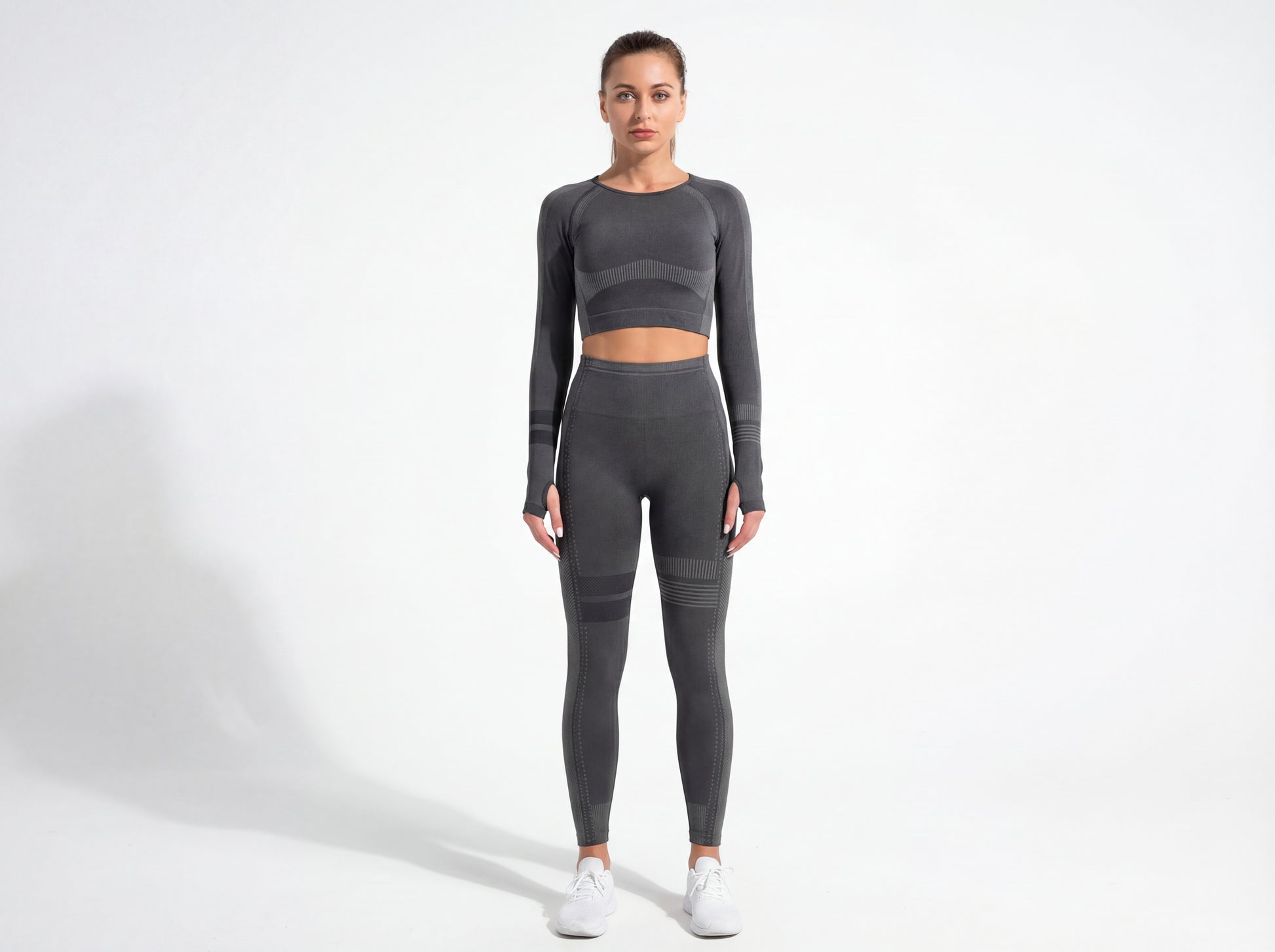 Model wearing the Shadow Flex Yoga Set by CHARMING BUNNY, featuring a fitted long-sleeve crop top and matching leggings in black, offering stylish support for workouts. Ideal for yoga and training sessions. APPAREL, BASICS & ACTIVEWEAR, Black, CCPRODUCTS, NEW ARRIVALS, SETS.