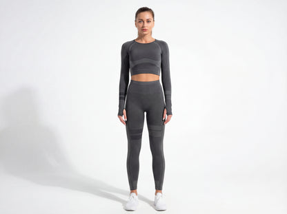 Model wearing the Shadow Flex Yoga Set by CHARMING BUNNY, featuring a fitted long-sleeve crop top and matching leggings in black, offering stylish support for workouts. Ideal for yoga and training sessions. APPAREL, BASICS & ACTIVEWEAR, Black, CCPRODUCTS, NEW ARRIVALS, SETS.