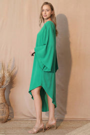 Side profile of the model wearing the TYCHE Matte Crepe One Sleeve Dress in bright green, highlighting the dress's sophisticated shape and fluid movement. This elegant outfit is part of APPAREL, CCPRODUCTS, Dress, DRESSES, Green, Matte Crepe One Sleeve Dress, NEW ARRIVALS, One Sleeve Dress, Women's Clothing.