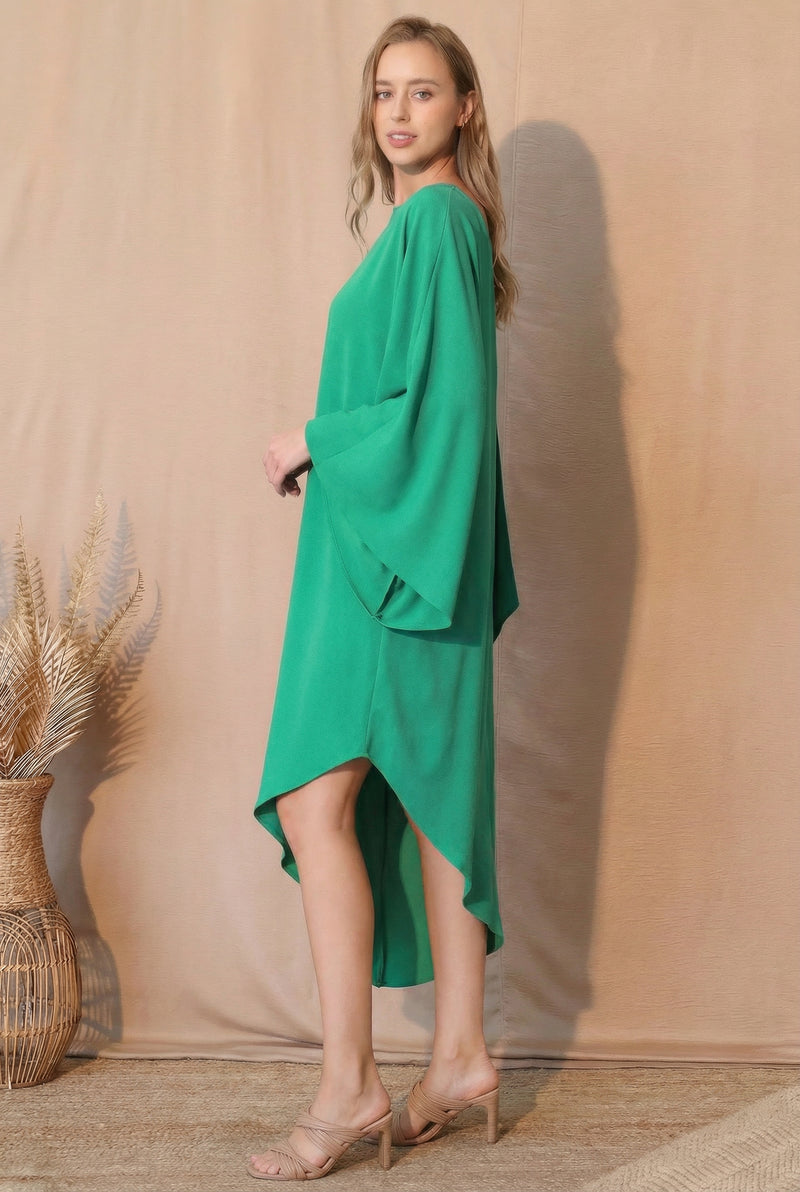 Side profile of the model wearing the TYCHE Matte Crepe One Sleeve Dress in bright green, highlighting the dress's sophisticated shape and fluid movement. This elegant outfit is part of APPAREL, CCPRODUCTS, Dress, DRESSES, Green, Matte Crepe One Sleeve Dress, NEW ARRIVALS, One Sleeve Dress, Women's Clothing.