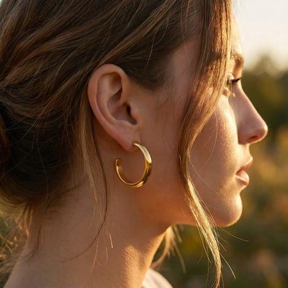 Close-up profile view of a woman wearing the 14K Gold Plated Golden Hour Earring Set by Astral Signature™, showcasing a chic and modern style. Perfect as a gift for her, this piece features Astral Design and is a limited edition item.
