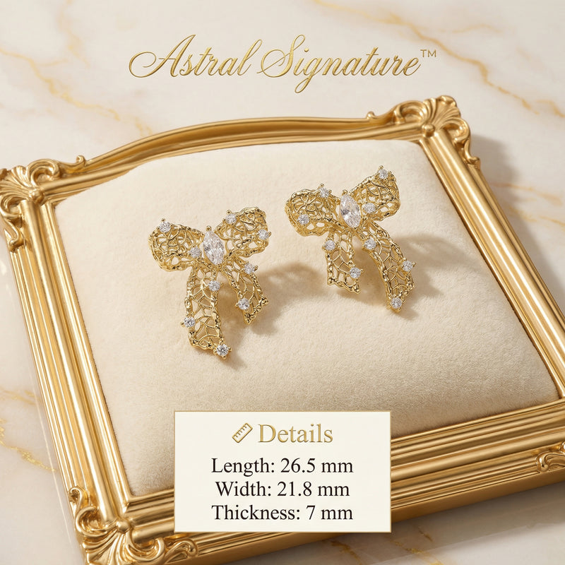 The Ribbon Dreams Bow Earrings by Astral Signature presented in a detailed shot, showcasing the 18K Gold Plated Eco-Brass material and sparkling zirconia. These elegant earrings are perfect Eco-Brass Earrings and a delightful Gift for Her, featuring hypoallergenic Sterling Silver (S925) posts.