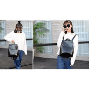 New model wearing the Urban Guard Backpack by Stevvex showcasing its shiny black finish, perfect for everyday use. Shop at Shopify Collective.