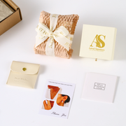 Contents of the Astral Signature jewelry set unboxing, featuring the 14K gold plated floral jewelry set with a note and care instructions.